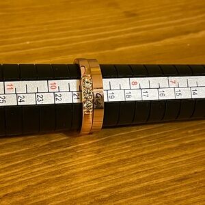 Rose gold rings size 9 with a “Gigi” engraved and 3 cubic zirconia